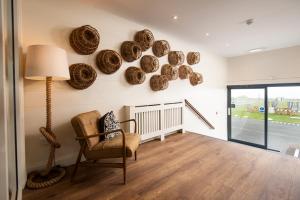 a living room with a chair and baskets on the wall at Beach House Hotel in Seahouses