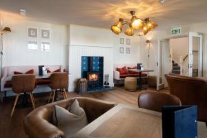 a living room with a couch and a fireplace at Beach House Hotel in Seahouses +139 photos