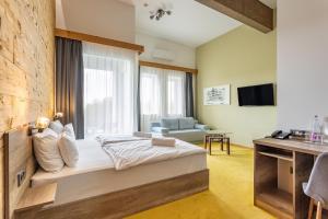 a bedroom with a bed and a large window at Hotel Kristály Konferencia & Wellness in Ajka