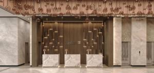 a lobby with a bunch of chairs in front of a wall at Radisson Blu Residences, Istanbul Kartal in Istanbul