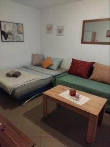 a living room with a couch and a table at Apartman "Vuković" in Bizovac