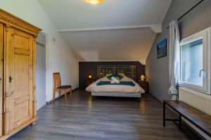 a bedroom with a bed and a wooden floor at Au doux passage in Les Rousses