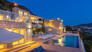 a villa with a swimming pool on top of a building at TEKCE Villa Dolly N24 in Kalkan