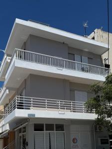 a white apartment building with a white balcony at Topfix Luxury Home 2 in Kos +9 photos
