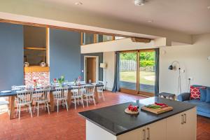 a kitchen and living room with a table and chairs at Peak Hall in Colkirk