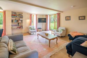a living room with a couch and a table at Peak Hall in Colkirk