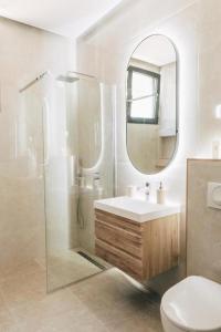 a bathroom with a shower and a sink and a mirror at Hayal Boutique in Bar +99 photos