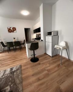 a living room with a kitchen and a table and chairs at R03 Central Residence in Sopron