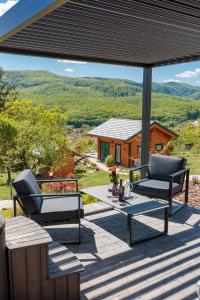 a patio with two chairs and a table on a deck at Bükk Hill Garden in Miskolc