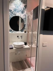 a bathroom with a sink and a mirror at Camere e attico al mare in Gabicce Mare