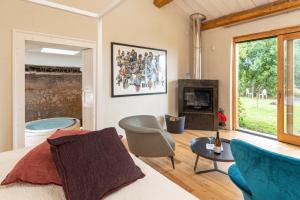 a living room with a bed and a fireplace at Monaci delle Terre Nere in Zafferana Etnea