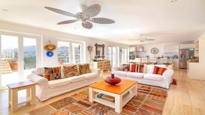 a living room with two white couches and a kitchen at TEKCE Villa Dolly N24 in Kalkan