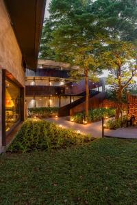 a building with a tree and lights in front of it at Wonderwall Hotel in Chiang Mai