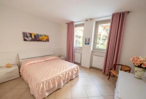 a bedroom with a bed and a table and windows at a casa di LUCA in Capriate San Gervasio +2 photos