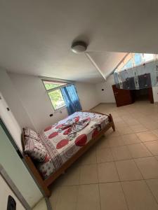 a bedroom with a bed in the corner of a room at Vila Emanuele in Shëngjin +5 photos