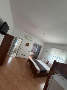 a bedroom with a bed and a television in it at Vila Emanuele in Shëngjin