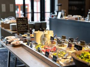 a buffet of food on a table in a restaurant at THE KNOT FUKUOKA Tenjin in Fukuoka +46 photos