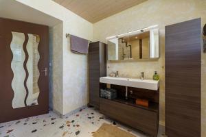 a bathroom with a sink and a mirror at Au doux passage in Les Rousses +29 photos