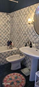 a bathroom with a white sink and a mirror at La Chambre d'Artiste in Laguépie