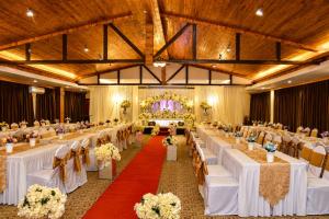 a banquet hall with white tables and chairs at INAP Melaka - Suites & Living in Malacca