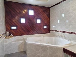 a large white tub in a bathroom with windows at Milliana House in Wallaroo +15 photos