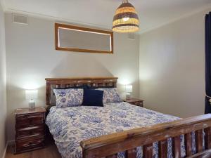 a bedroom with a bed and a pendant light at Milliana House in Wallaroo