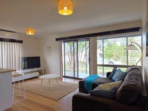 a living room with a couch and a tv at Milliana House in Wallaroo
