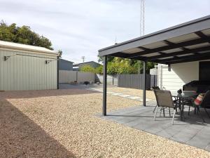 a patio with a table and chairs under a pavilion at Milliana House in Wallaroo