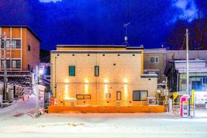a large brick building with lights on it at night at Shirakaba in Otaru +85 photos
