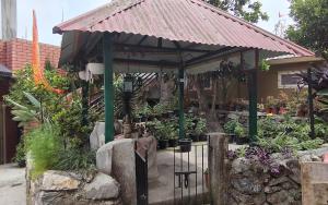 a garden with a pavilion with potted plants at Marigold in Kalimpong
