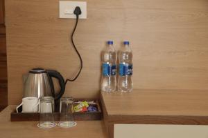 three bottles of water are attached to a wall at Hotel Radha Vallabh in Ukhimath