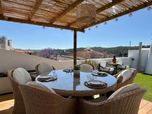 a table and chairs on a patio with a view at Casa do Castelo by CORAL in Silves