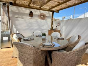 a dining table and chairs on a patio at Casa do Castelo by CORAL in Silves