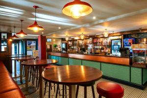 a bar with tables and chairs in a restaurant at E21 The Sandy Heaven in Lossiemouth
