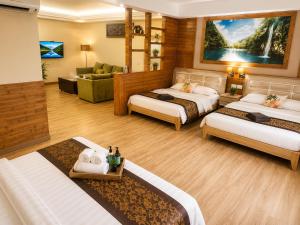 a hotel room with two beds and a living room at INAP Melaka - Suites & Living in Malacca +6 photos