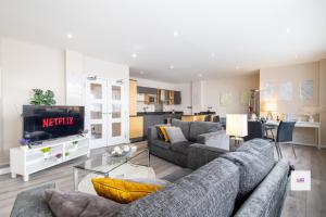 a living room with two couches and a tv at Brighton central stylish stays. Walk to the beach. in Brighton & Hove