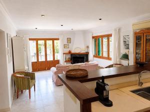 a kitchen and living room with a counter top at Vila Mimosa in Colonia de Sant Pere