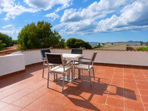a patio table and chairs on a roof at Vila Mimosa in Colonia de Sant Pere +10 photos