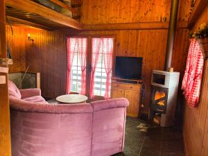 a living room with a couch and a stove at La Granzeta - Chalet- Authentique - Evolene in Evolène