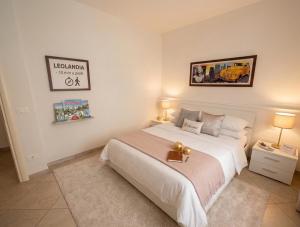 a bedroom with a large white bed and two lamps at a casa di LUCA in Capriate San Gervasio