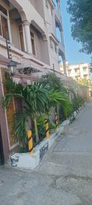 a building with a bunch of plants in front of it at The Folks Inn in Mombasa