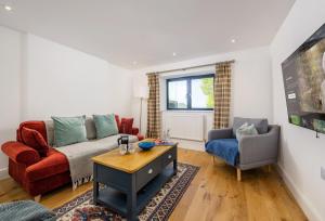a living room with a couch and two chairs at Pentreath in Bude