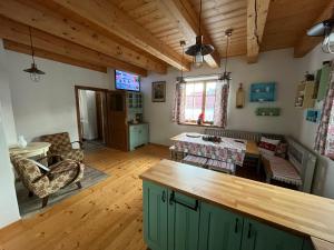 a living room with a kitchen and a dining room at Chalúpka Barborka in Lúčky