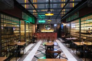 a restaurant with tables and chairs and a clock on the wall at Boris Hotel Istanbul Beylikduzu in Beylikduzu