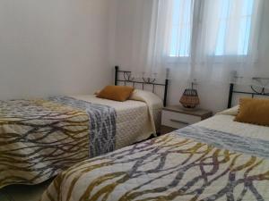 a bedroom with two beds and a window at Chalet Garcia in Deltebre +63 photos