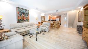 a living room with two couches and a table at 609 Mariners Club in Key Largo