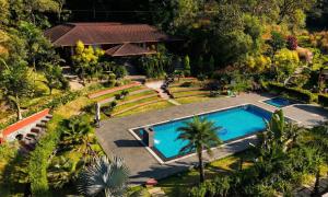 an aerial view of a house with a swimming pool at Hong Sau Resort - Luxury Nature Escape, Sakleshpur in Sakleshpur