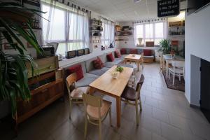 a restaurant with a table and chairs and a couch at Andělka maringotka in Humpolec