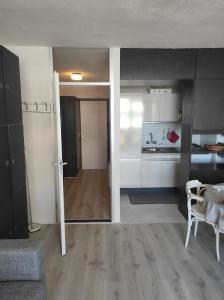 a living room with a kitchen and a dining room at Westdiep 602 zeezicht, verwarmd binnenzwembad in De Panne