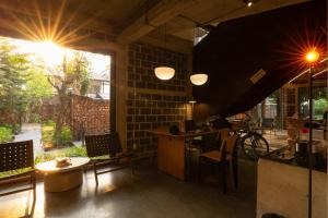 a restaurant with a counter and a table and chairs at Wonderwall Hotel in Chiang Mai